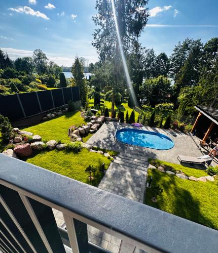 a backyard with a swimming pool and a garden at Ostoya Zawory -domki premium ,strefa relaksu, basen in Zawory