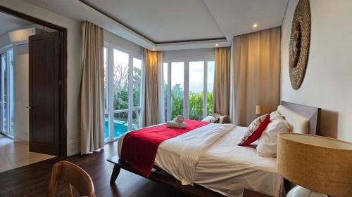 une chambre avec un lit et une grande fenêtre dans l'établissement Araya Luxe Villa, à Munggu