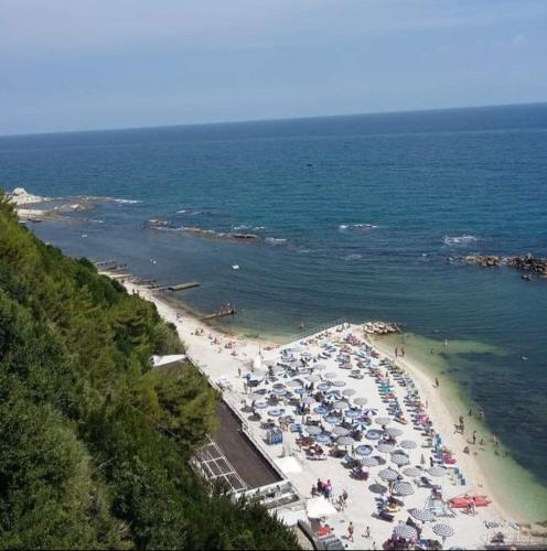 a beach with many umbrellas and people on it at Civico11 in Ancona