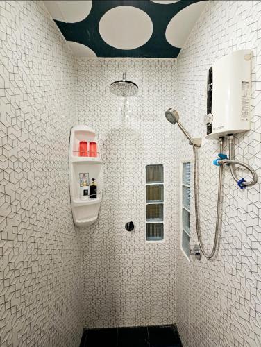 a bathroom with a shower and a sink at DDM House in Bangkok