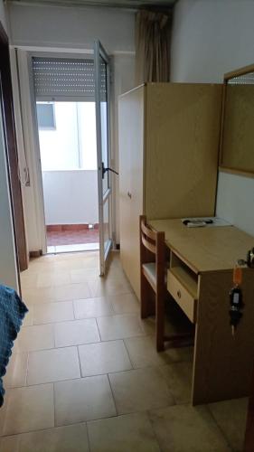 a room with a desk and a door to a room at San Domenico Hotel in Soverato Marina