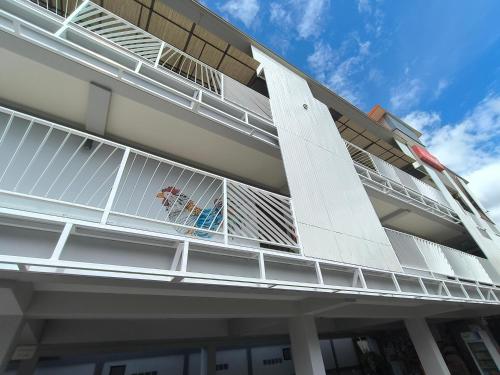 a balcony of a building with white metal railing at Le Neuf Nakorn Lampang in Lampang