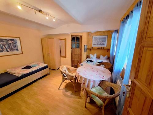 a room with a bed and a table and chairs at Michałowa Zagroda 2 in Piechowice