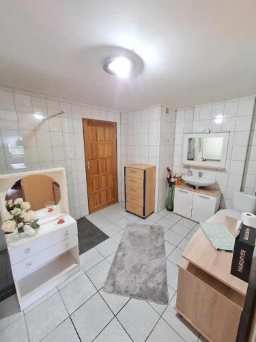 a room with a bathroom with a sink and a mirror at Michałowa Zagroda 2 in Piechowice