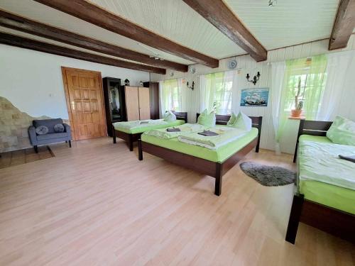 a large room with two beds and a couch at Michałowa Zagroda 2 in Piechowice