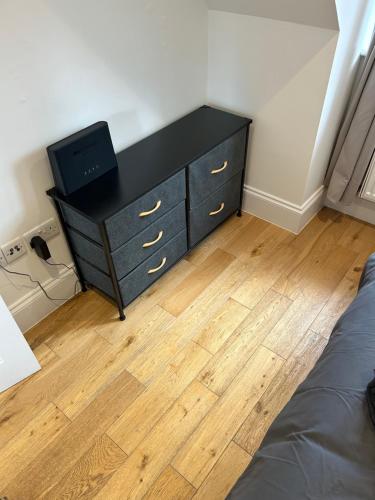 a bedroom with a dresser with a tv on it at Luxury Penthouse Appartment in Cobham