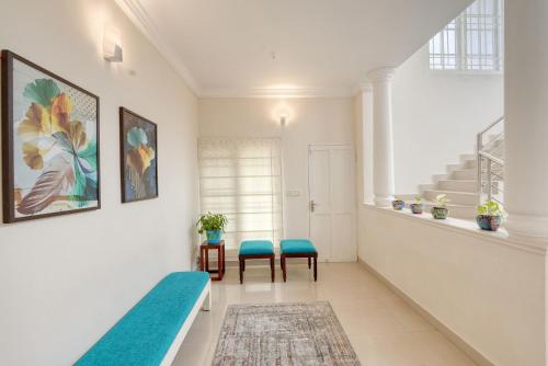 a room with a bed and a table and chairs at The Oval House, Kochi - Approved by Kerala Tourism - Exclusively for Families in Cochin
