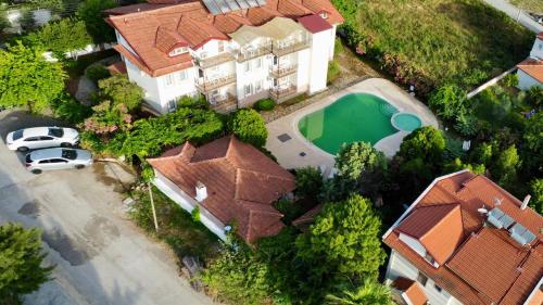 an overhead view of a house with a car and a pool at Angels Garden Dalyan in Dalyan