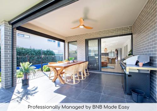 a kitchen and dining room with a large sliding glass door at Macquarie Entertainer - Pool Retreat, Pet Friendly in Dubbo