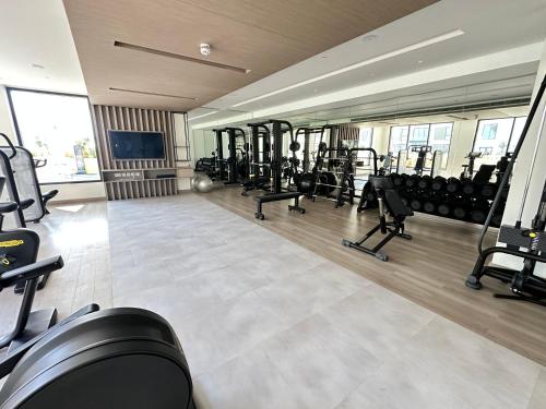 a gym with a row of treadmills and weights at Marassi Beach Residence Bahrain in Rayyā