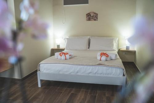 a bedroom with a bed with two pillows on it at Casa Badia in Santa Venerina