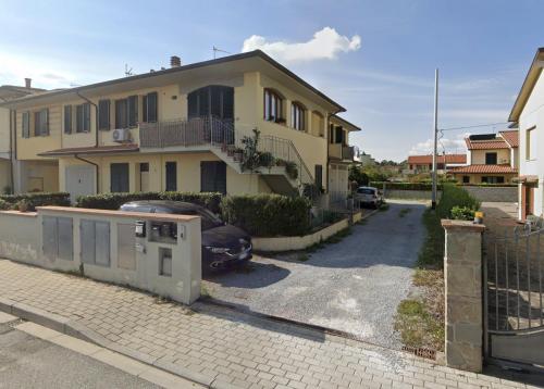 a house with a car parked in a driveway at Casaticcio in Capannoli