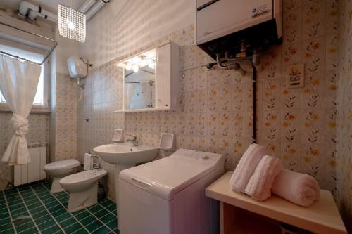 a bathroom with a sink and a toilet and a mirror at Casa Vista Mare e Parcheggio in Marotta