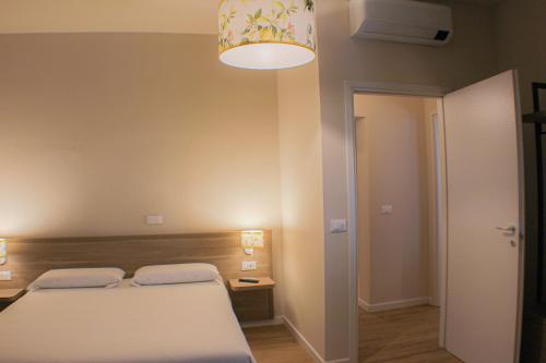 a bedroom with a bed and a light fixture at Da Arturo e Maruca suites con 2 camere in Vellano