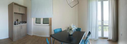 a dining room with a table and blue chairs at Da Arturo e Maruca suites con 2 camere in Vellano