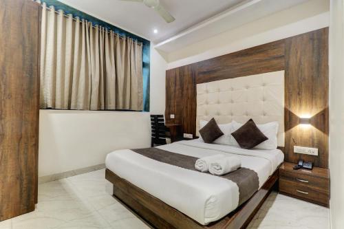 a bedroom with a large bed and a window at Hotel A. K. International - Fort in Mumbai