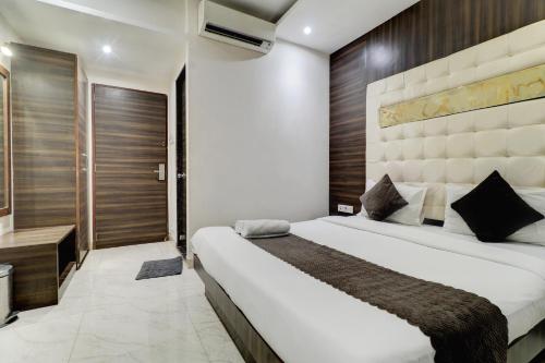a bedroom with a large bed in a room at Hotel A. K. International - Fort in Mumbai