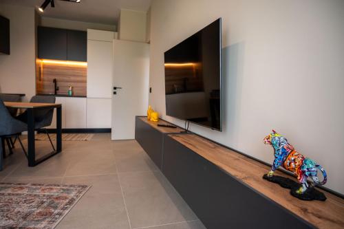 a living room with a large flat screen tv on a wall at Sonata Apartment Sofia in Sofia