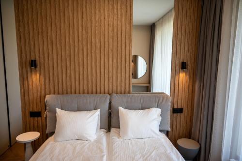a bedroom with a bed with two white pillows at Sonata Apartment Sofia in Sofia