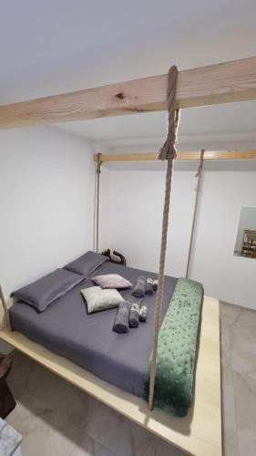 a bed in a room with a swing at Luxury Beach House in Bari