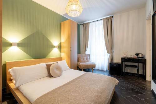 a bedroom with a bed and a desk and a chair at I Remi Del Prione by Le 5 Terre La Spezia in La Spezia