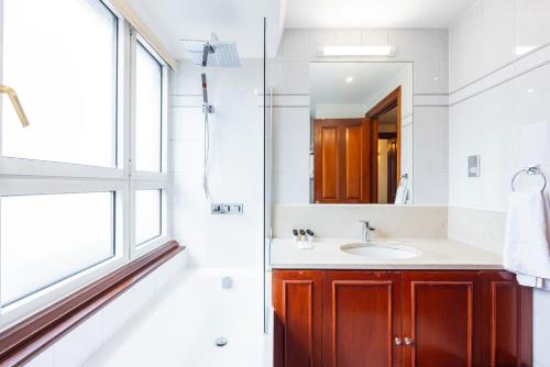 a bathroom with a sink and a mirror at CARLTON COURT - MAYFAIR in London