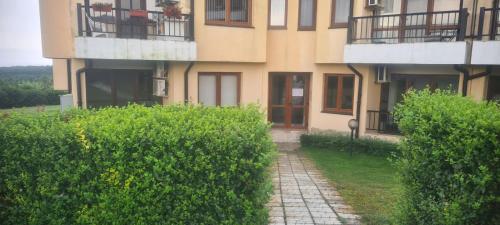 a building with a path in front of it at Apartment Oasis A4 Kamchia in Bliznatsi