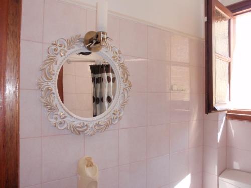 a bathroom with a mirror on the wall at Vazakas Rooms in Mytilene