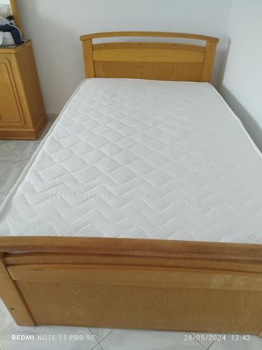 a bed in a room with a white mattress at Golden Beach 1 for family in Ras Sedr