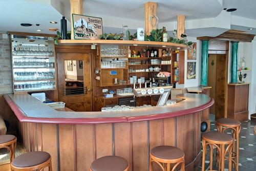 a bar in a restaurant with stools at Pension Waldviertel in Groß-Siegharts