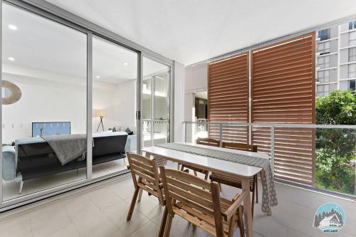 a room with a table and chairs and a bedroom at Aircabin - Mascot - Comfy - Family-2 Beds Apt in Sydney