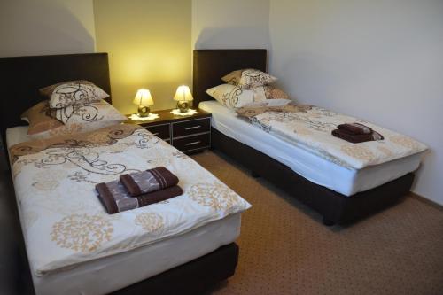 two beds in a hotel room with chocolate on them at Astra Apartments in Oświęcim