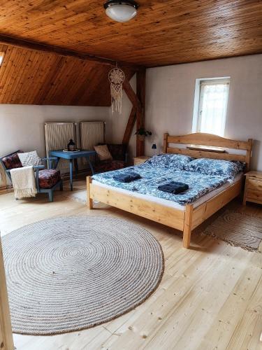 a bedroom with a bed and a wooden ceiling at Tuhaň dům na samotě u lesa in Tuhaň