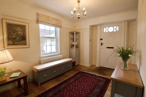 a living room with a bench and a window at Exquisite location close to the sea! in Frinton-on-Sea
