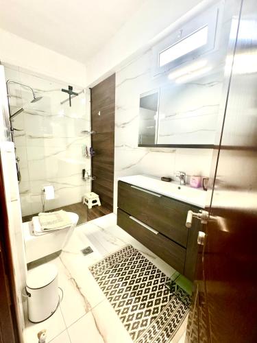 a bathroom with a toilet and a sink at Villa Katerina in Kos