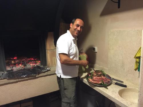 a man standing in a kitchen with a plate of food at Country House Casco Dell'Acqua in Trevi