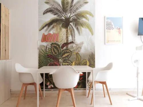 une salle à manger avec une fresque murale sur les palmiers dans l'établissement Le TIKAL studio 4 pers, centre-ville port, clim, à La Grande Motte