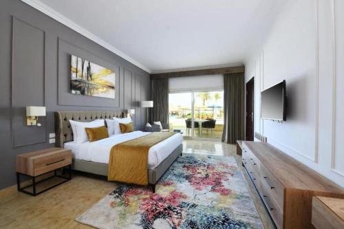 a bedroom with a king sized bed and a television at Eastern El-Galala Aquapark Ain Sokhna in Ain Sokhna