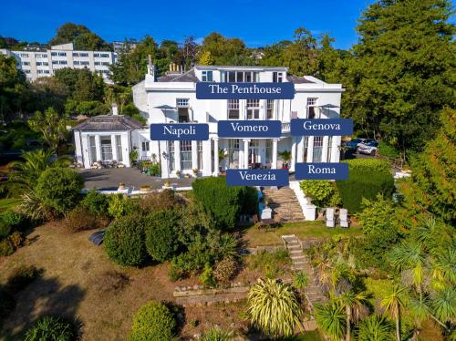 an aerial view of a large white house at Vomero Holiday Apartments in Torquay