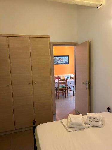 a bedroom with a bed and a dining room at Sofia Apartments in Paralía Iríon