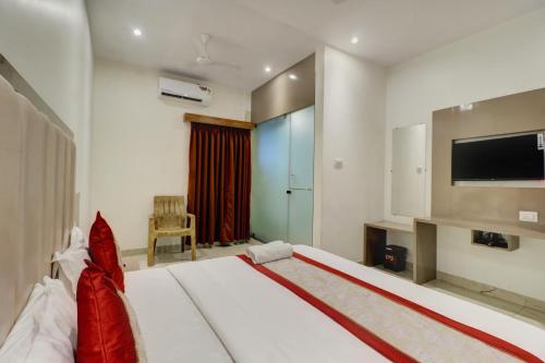 a bedroom with a large bed with a flat screen tv at Hotel A K Fort Inn in Mumbai
