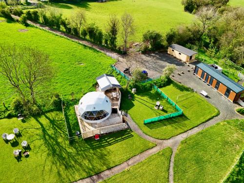 an aerial view of a domed house in a field at Little River Glamping in Ballymoney