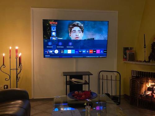 een woonkamer met een flatscreen-tv aan de muur bij Entire home close to Hamburg, train&airport nearby in Norderstedt
