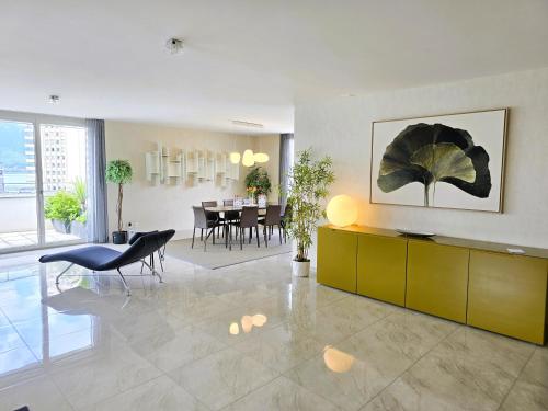 a living room with a table and a dining room at Montreux Four Bedroom Penthouse by Swiss Hotel Apartments in Montreux