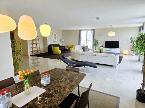 a living room with a couch and a table at Montreux Four Bedroom Penthouse by Swiss Hotel Apartments in Montreux