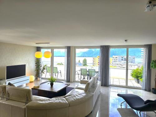 a living room with a couch and a table at Montreux Four Bedroom Penthouse by Swiss Hotel Apartments in Montreux