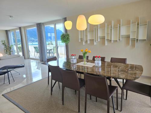 a dining room with a dining table and chairs at Montreux Four Bedroom Penthouse by Swiss Hotel Apartments in Montreux
