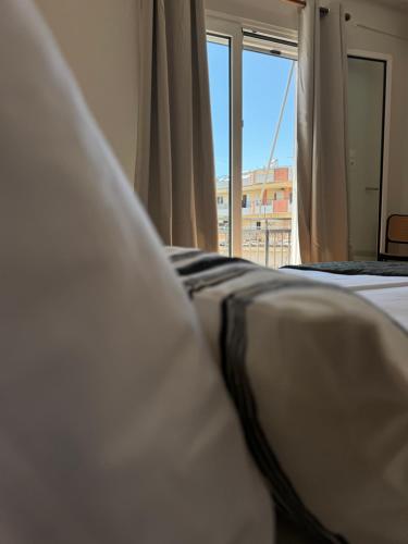 a close up of a bed with a window at Molys House in Igoumenitsa
