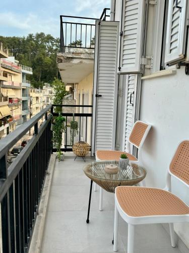 a balcony with chairs and a table on a building at Molys House in Igoumenitsa