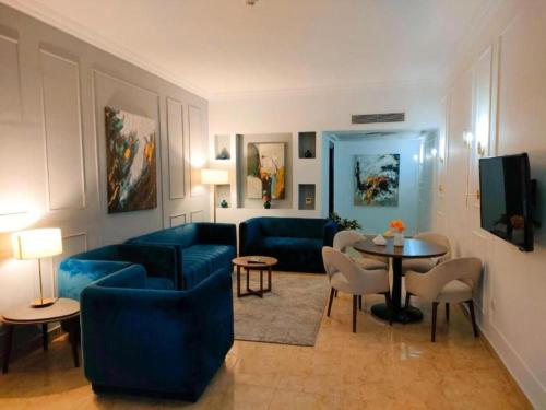a living room with blue couches and a table at Eastern El-Galala Aquapark Ain Sokhna in Ain Sokhna